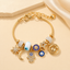 Bracciale con ciondoli celesti – Bracciale a strati con ciondoli Occhio di Allah, Sole, Luna e Stella color oro